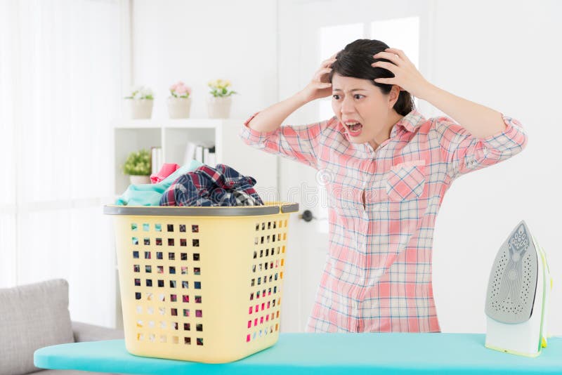 Unhappy young housewife showing shocked emotional royalty free stock photography Unhappy young housewife showing shocked emotional royalty free stock photography