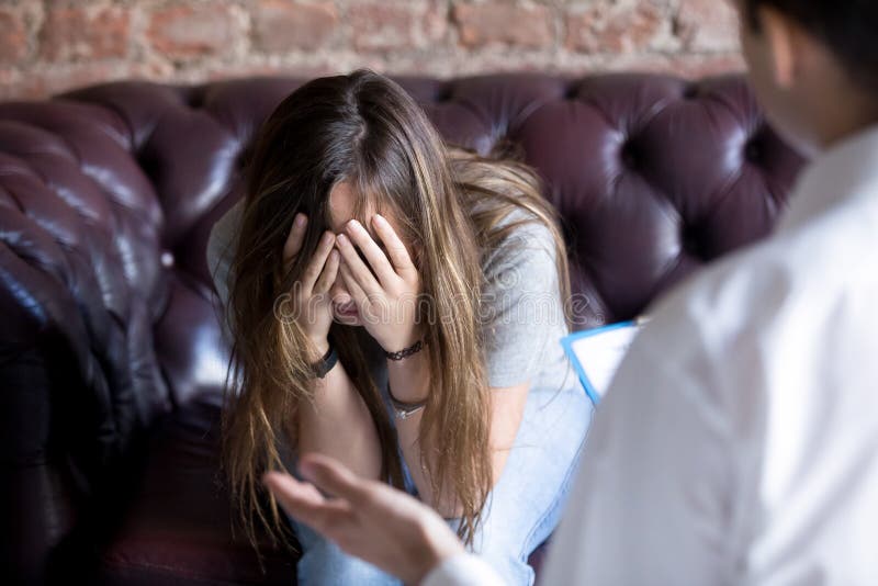 Unhappy young woman at a psychologist counselor reception. royalty free stock photo