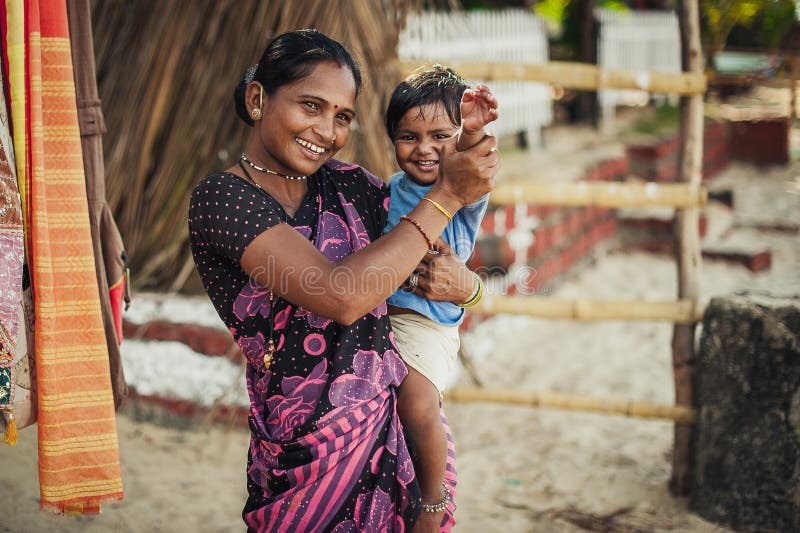 Unidentified Indian woman and baby in her arms are smiling with very royalty free stock photography