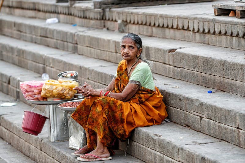 Unidentified Indian woman doing business on the ghats of the old city centre of Varanasi, India