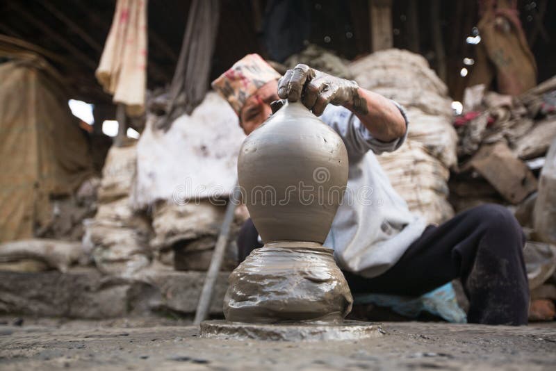 Unidentified Nepalese man working in the his pottery workshop. royalty free stock images