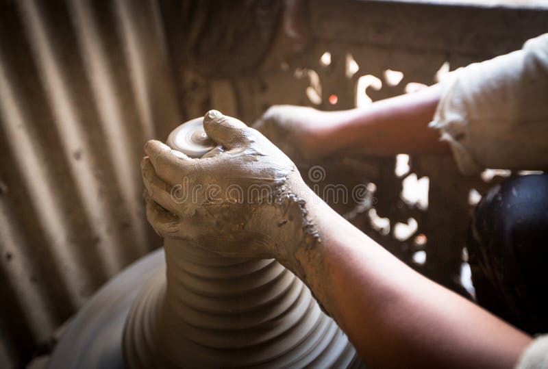 Unidentified Nepalese man working in the his pottery workshop. stock photo