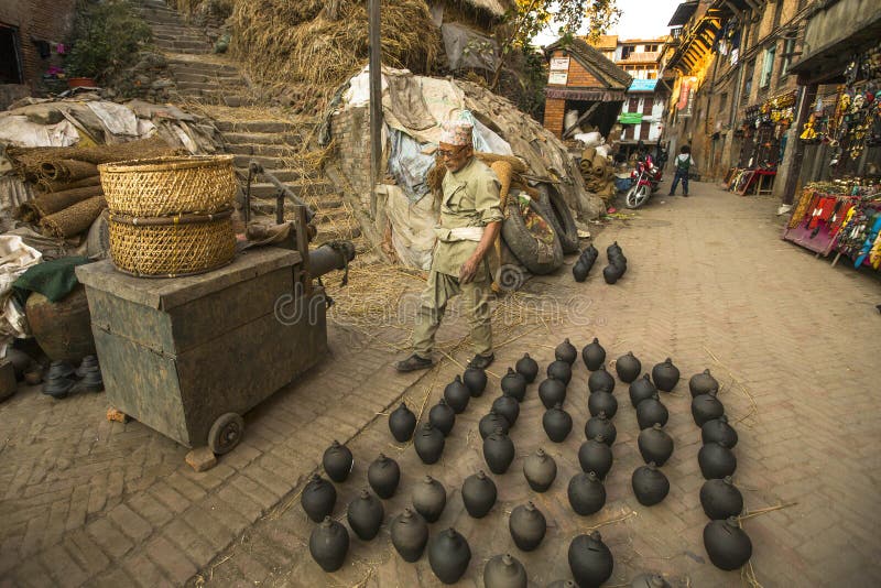 Unidentified Nepalese man working in the his pottery workshop. royalty free stock photo