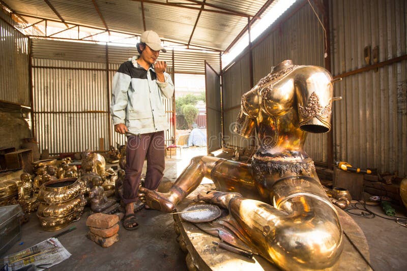 Unidentified Nepalese tinman working in the his workshop. royalty free stock photography