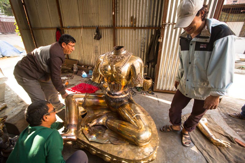 Unidentified Nepalese tinman working in the his workshop. stock photo