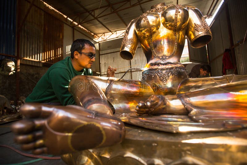 Unidentified Nepalese tinman working in the his workshop. stock photography