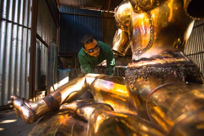 Unidentified Nepalese tinman working in the his workshop. royalty free stock photos