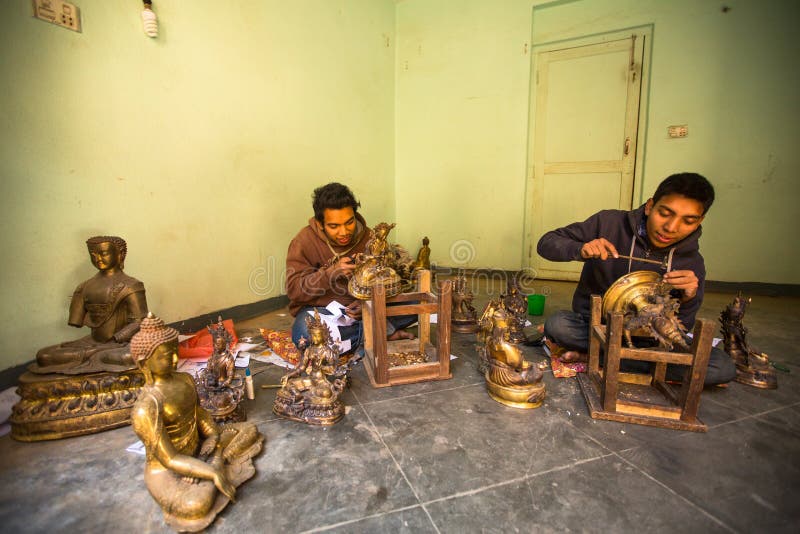 Unidentified Nepalese tinman working in the his workshop. royalty free stock photo