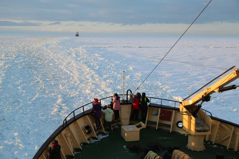 Unidentified tourists aboard the arctic Icebreaker Sampo during unique cruise in frozen Baltic Sea.