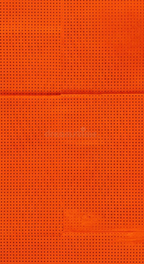 Uniform orange surface with a consistent pattern of small, dark dots. A subtle horizontal crease is visible stock illustration