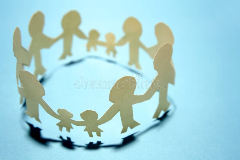 A metaphorical image of a paper cutout of families making a circle holding hands, depicting unity. A metaphorical image of a paper cutout of families making a circle holding hands, depicting unity.