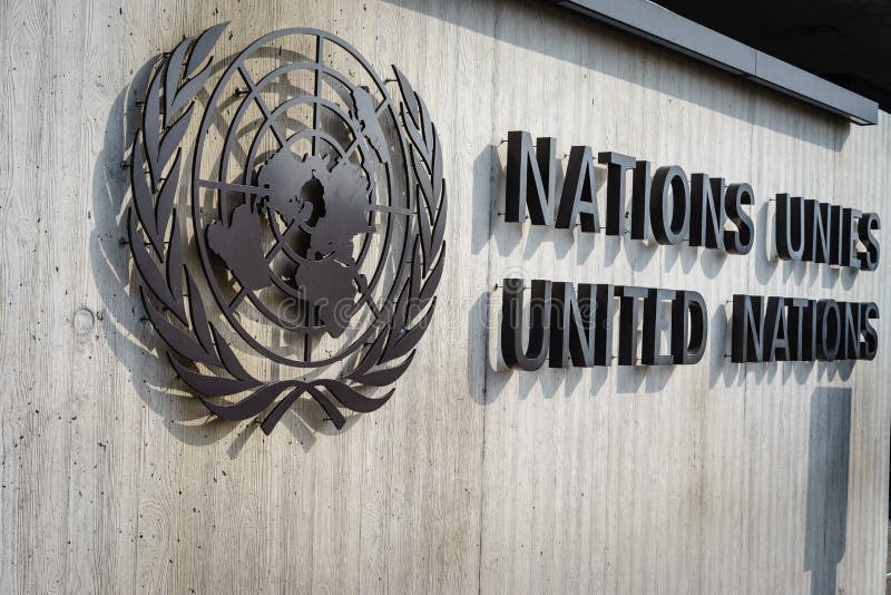 United Nations Badge in Geneva. United Nations Badge at the front entrance of the Palais des Nations in Geneva, Switzerland. Photo taken on: March 11, 2014 United Nations Badge in Geneva. United Nations Badge at the front entrance of the Palais des Nations in Geneva, Switzerland. Photo taken on: March 11, 2014