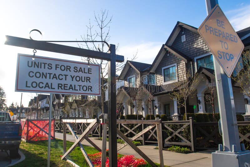 Units for sale contact your local realtor sing. In front of a house in a residential neighborhood. stock photo Units for sale contact your local realtor sing. In front of a house in a residential neighborhood. stock photo