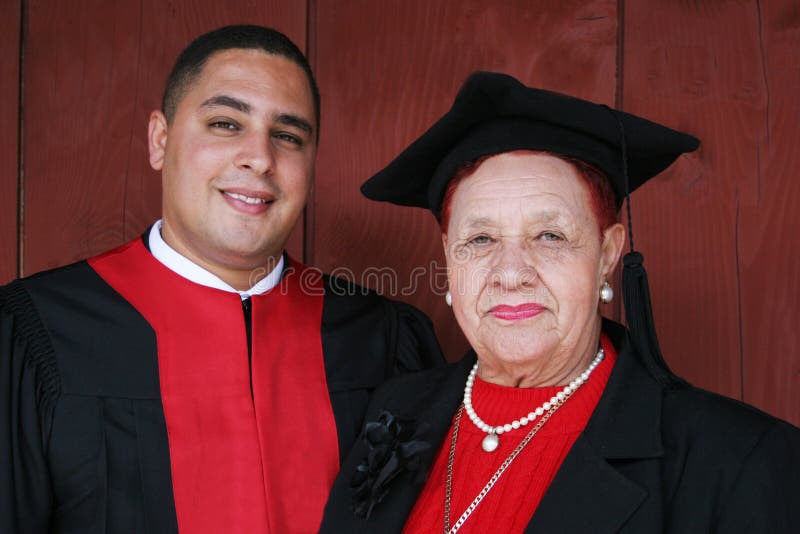 University graduate in robes with his grandmother.