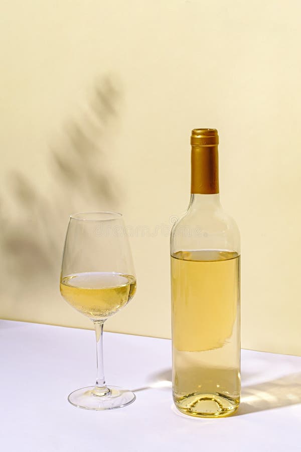 Unlabelled bottled of white wine with wineglass