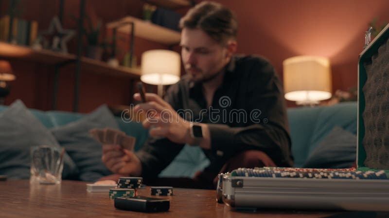 Unlucky sad frustrated Caucasian man male guy player gambler playing poker cards lost game blackjack defeat competition upset stressed gamer smoking cigar betting losing wager gambling addiction home. High quality 4k footage. Bad player stock images, royalty-free photos and pictures