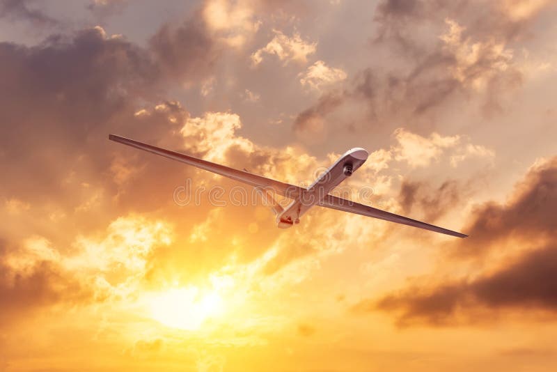 Unmanned military drone flies the at sunset clouds sky stock images Unmanned military drone flies the at sunset clouds sky stock images