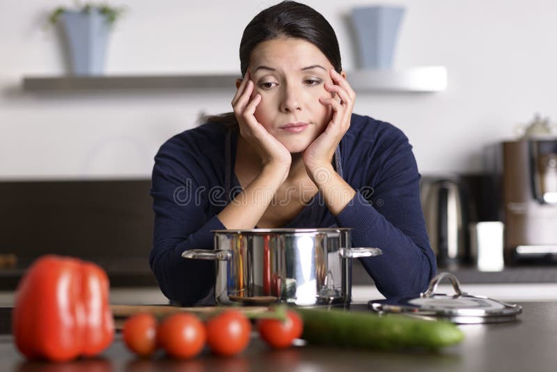 Unmotivated woman preparing the dinner