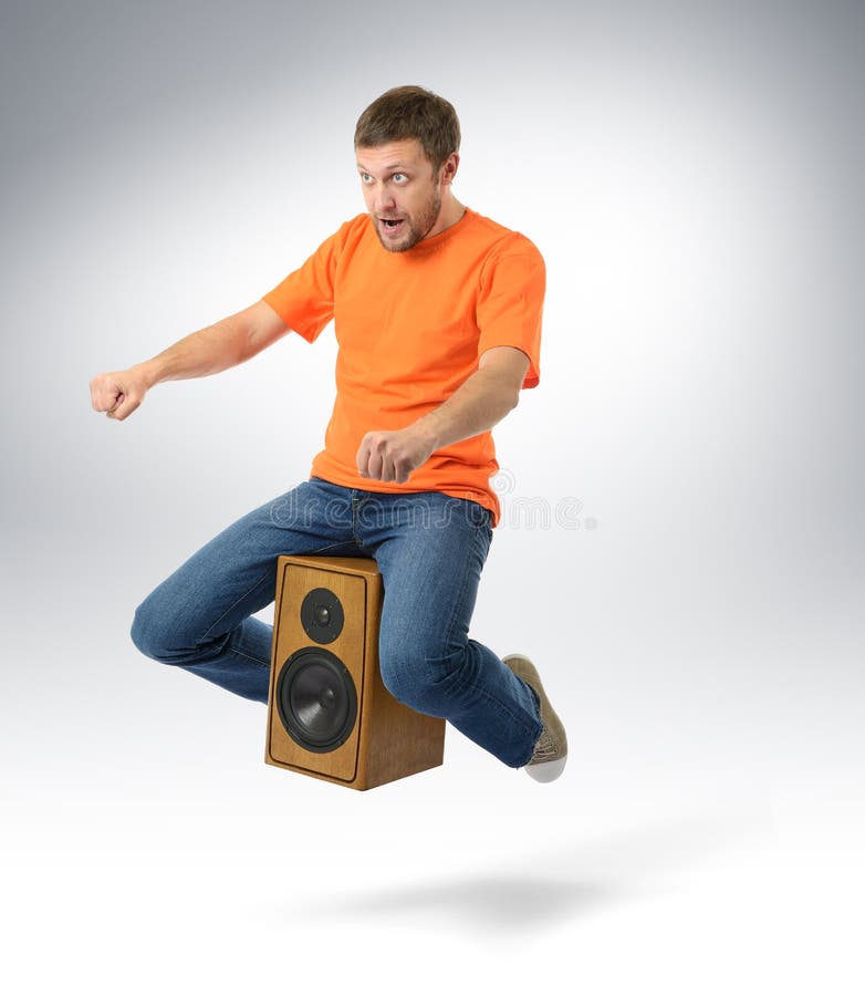 Unreal flying man sitting on a speaker