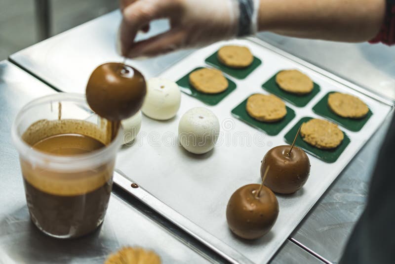 Unrecognisable Baker Glazing and Assembling Caramel Apple Desserts