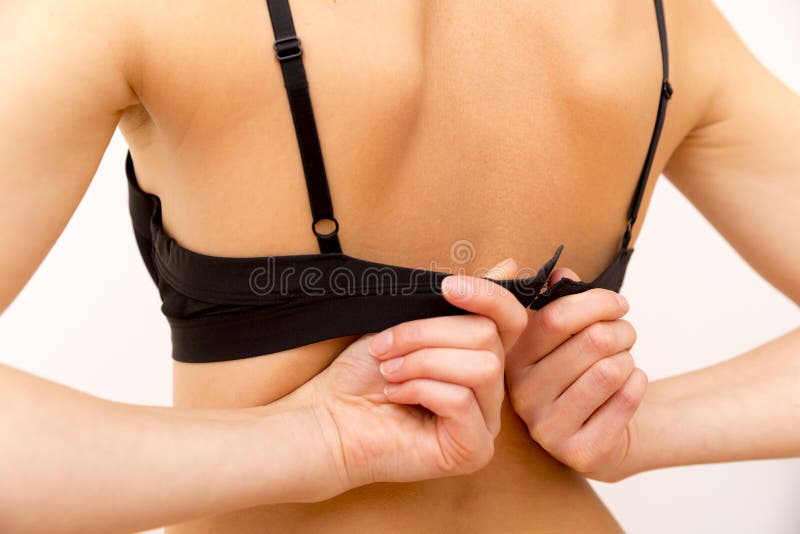 Unrecognizable Female Back with Hands Opening Bra Stock Image