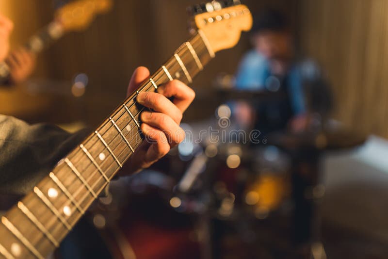 Unrecognizable Human Hand Touching Neck and Strings of Professional