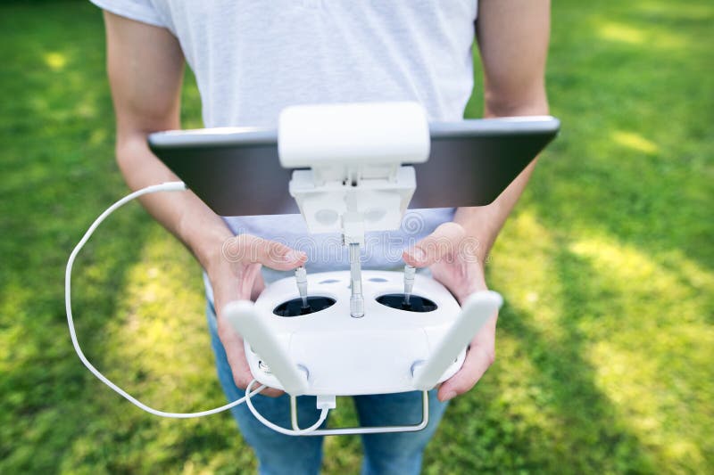 Unrecognizable man with remote control. Sunny green nature. royalty free stock photos