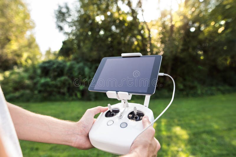 Unrecognizable man with remote control. Sunny green nature. royalty free stock photos