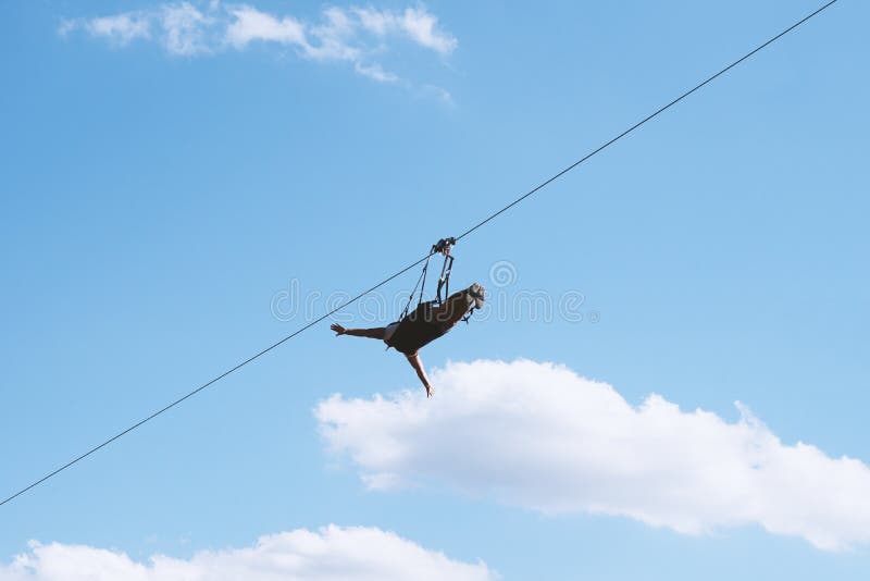 Unrecognizable person ziplining with zip line