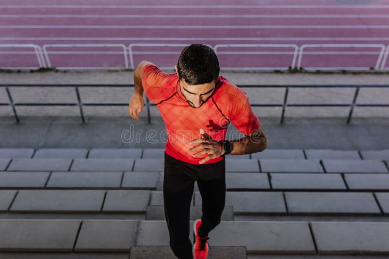 Unrecognizable young athlete man running in the steps. Daylight. Sports concept