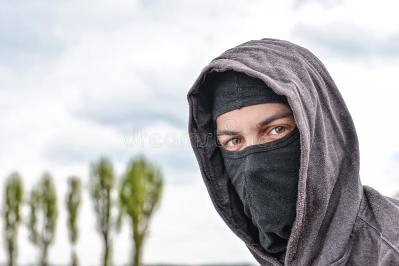 Unrecognizable Young Man Wearing Black Balaclava Sitting on Old Stock ...
