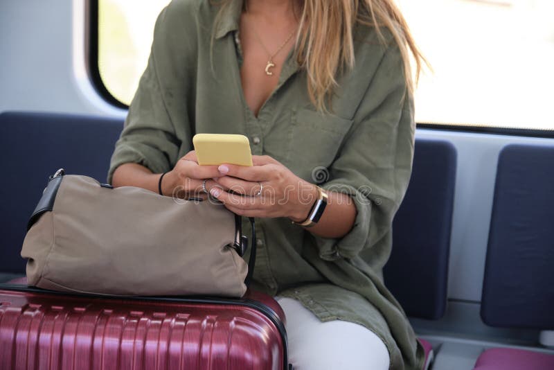 Unrecognizable young woman using her smartphone while is traveling by train royalty free stock images