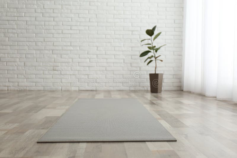 Yoga Mat on Wooden Floor in Empty Room in Yoga Studio Stock Image