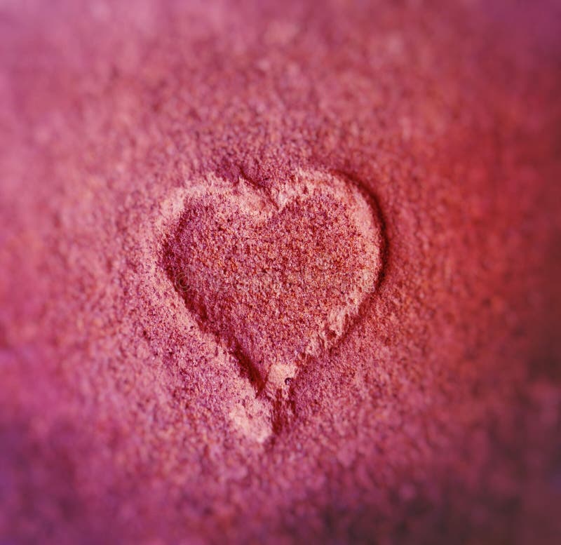 Blurred pink Heart shape in the old brick stone from up close. Blurred pink Heart shape in the old brick stone from up close