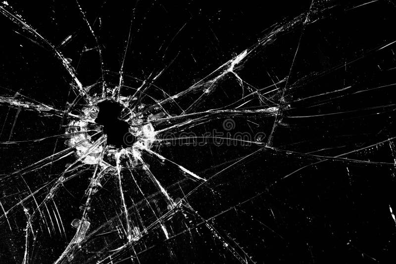 Broken glass - cracked with hole over black. Broken glass - cracked with hole over black