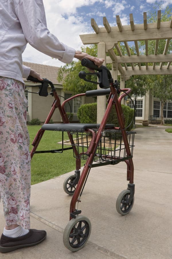 Elderly woman using a walker and staying active in an outdoor setting. Elderly woman using a walker and staying active in an outdoor setting