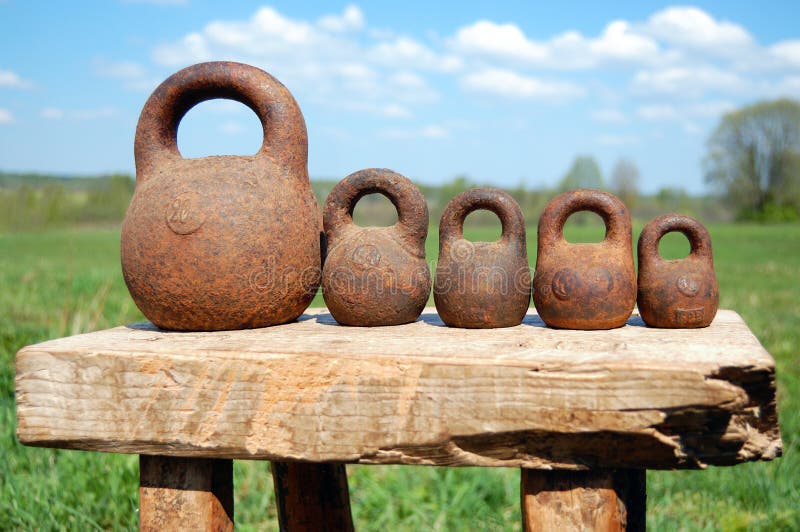 Different old-fashioned weights unit over a landscape. Different old-fashioned weights unit over a landscape