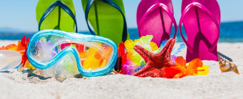 Scuba mask and colorful flip flops on the beach in summer. Scuba mask and colorful flip flops on the beach in summer