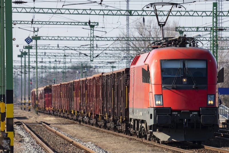 Untitled cargo train locomotive at railway train station. Platform track view. International freight. Cargo shipping