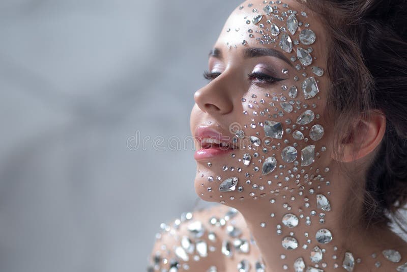 Unusual Makeup and Face Art with Sparkling Rhinestones on the Skin