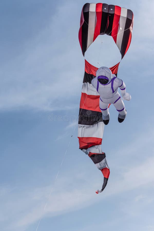 Cellular kite and Spaceman flying stock photo