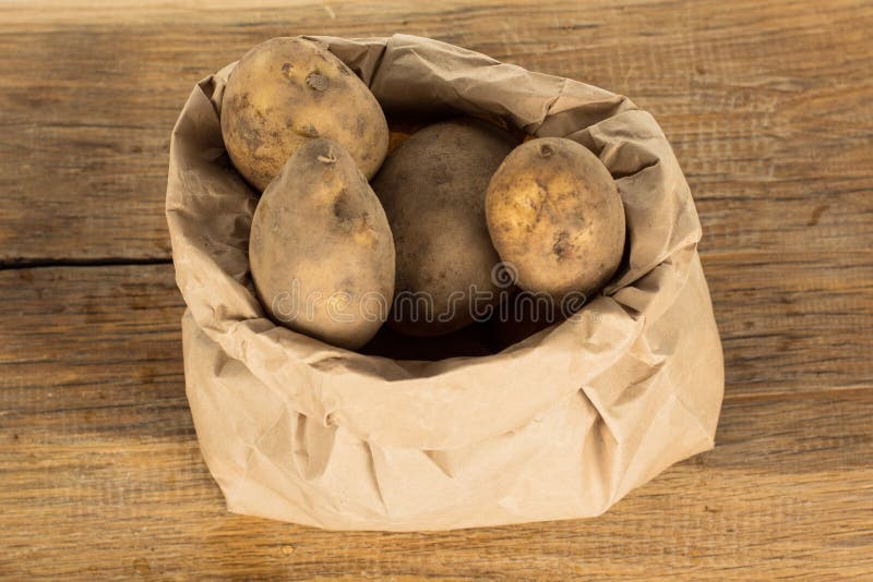 Unwashed Potatoes in a Paper Bag Islated on White Stock Photo Image