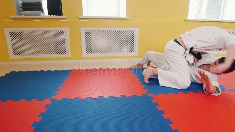 Uomini atletici che preparano le loro abilità di aikidi nello studio Tecnica di protezione