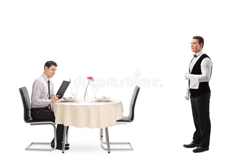 Young men seated at a restaurant table reading a menu and a waiter waiting to be called isolated on white background. Young men seated at a restaurant table reading a menu and a waiter waiting to be called isolated on white background