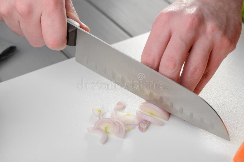 Uomo che affetta una cipolla fotografie stock libere da diritti Uomo che affetta una cipolla fotografie stock libere da diritti
