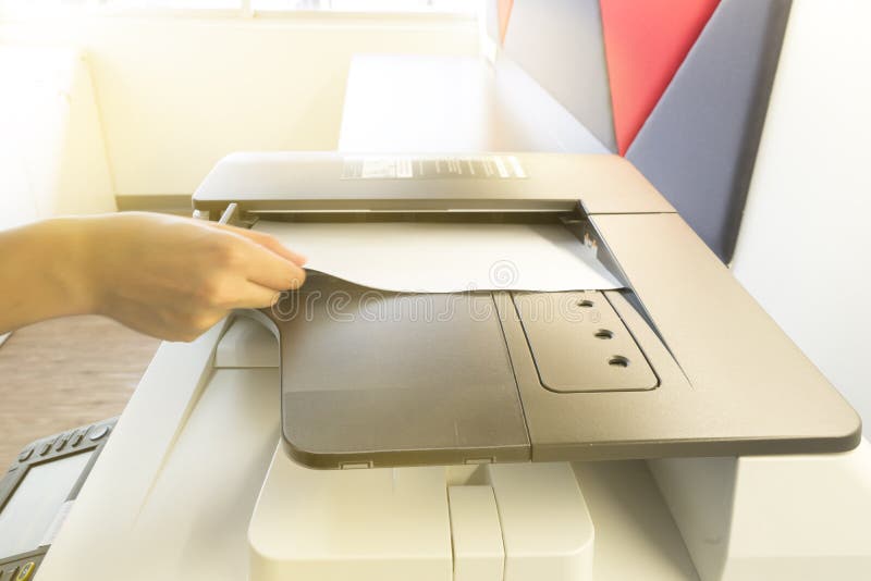 Uomo che fa fotocopia con il foglio di carta sulla fotocopiatrice con il pannello del controllo di accesso immagini stock libere da diritti Uomo che fa fotocopia con il foglio di carta sulla fotocopiatrice con il pannello del controllo di accesso immagini stock libere da diritti