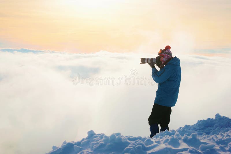 Zakopane, Poland - January 8, 2015: Man taking photos on top of Kasprowy Wierch in Zakopane at winter. Kasprowy Wierch is a mountain in Zakopane and is the most popular ski area in Poland. Zakopane, Poland - January 8, 2015: Man taking photos on top of Kasprowy Wierch in Zakopane at winter. Kasprowy Wierch is a mountain in Zakopane and is the most popular ski area in Poland