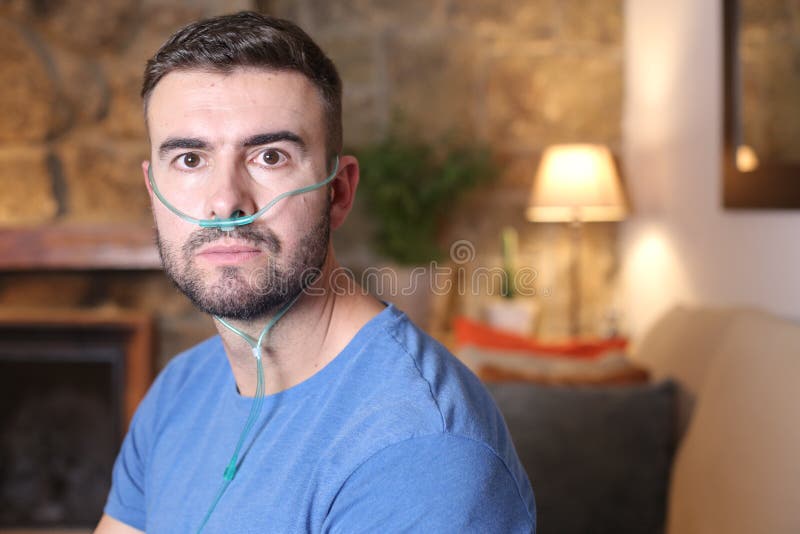 Man receiving oxygen through nasal tube. Man receiving oxygen through nasal tube.