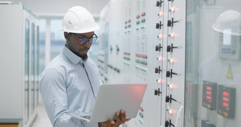 Uomo che utilizza un portatile mentre lavora in una stanza server stock footage