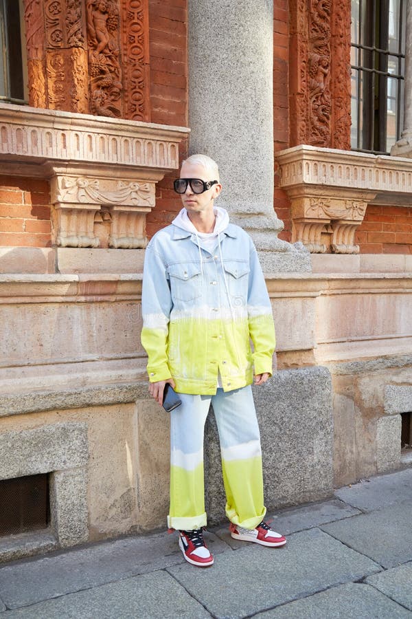 Uomo con occhiali da sole gucci e giacca di jeans gialla e bianca blu e pantaloni prima della sfilata di moda msgm milano fotografia stock